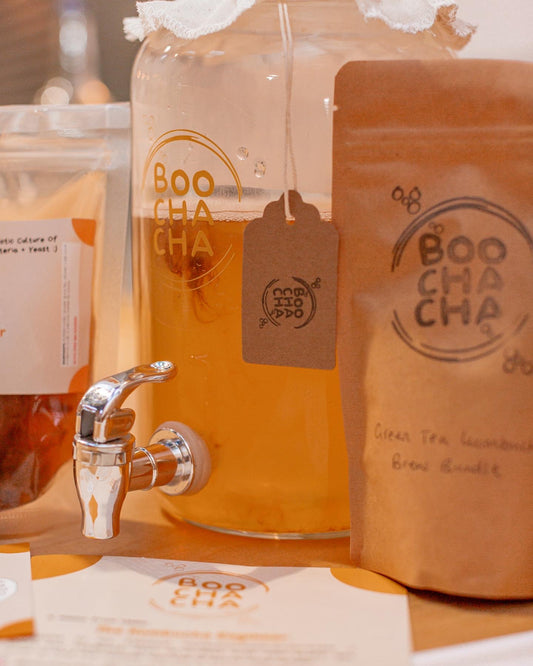 Image of kombucha starter kit from boochacha in action, with scoby floating around, looks fashionable and contemporary - boochacha