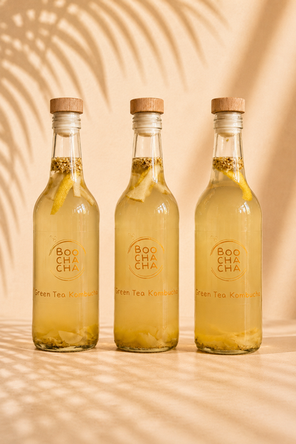 three bottles of homemade boochacha kombucha with reusable cork lids