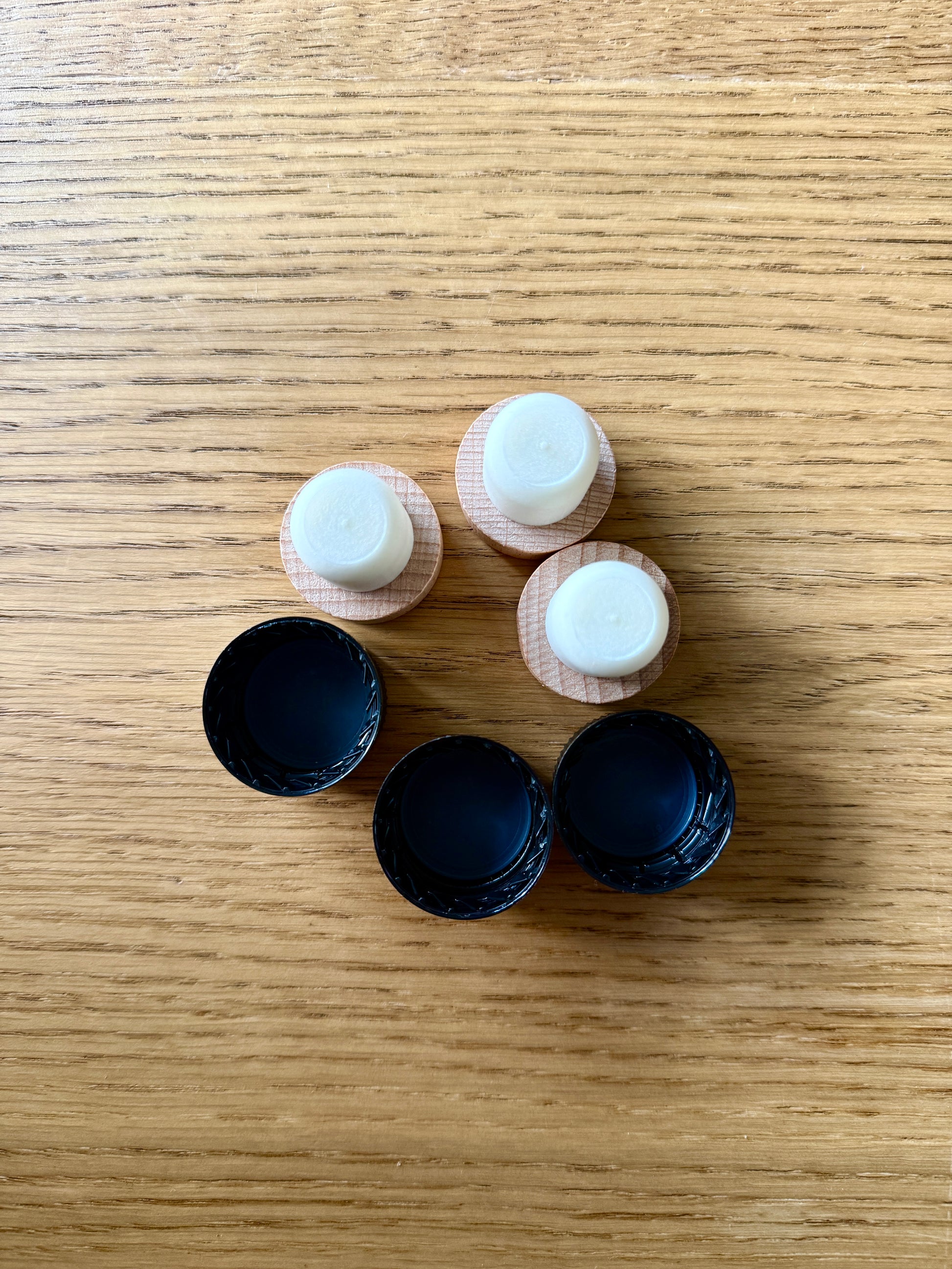 Set of small fermentation safe lids for bottles to make kombucha at home on a wooden surface