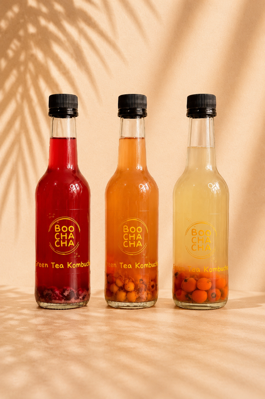 three mini bottles of homemade boochacha kombucha, with different flavours in each. boochacha branding. 